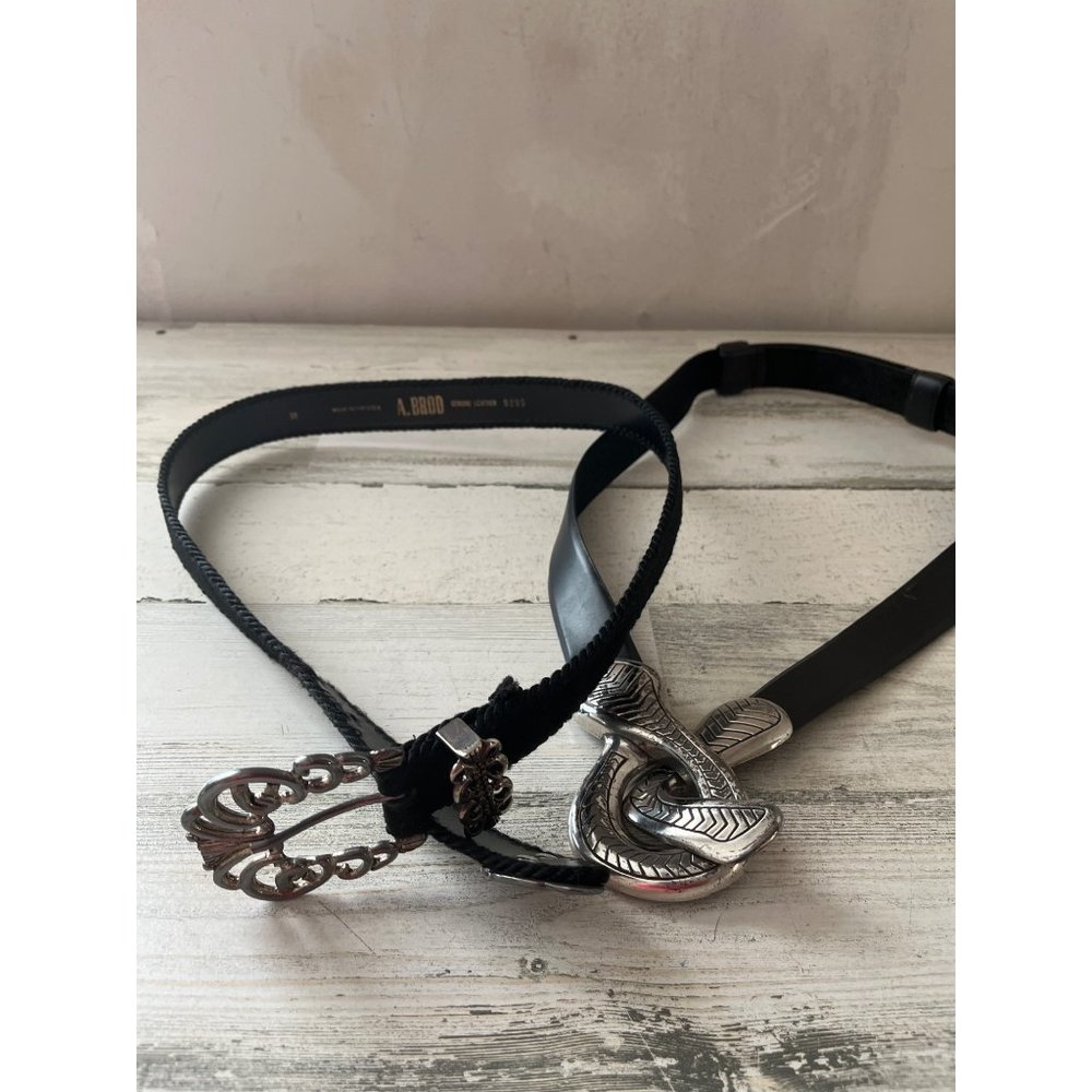 Set of two woman’s leather fashion belts with silver tone buckles